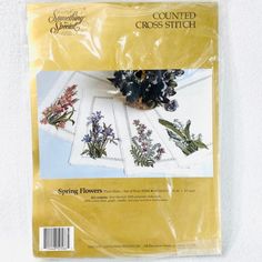 a package of cross stitch kits with flowers on them