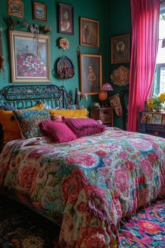 a bed in a room with many pictures on the wall and colorful bedspread