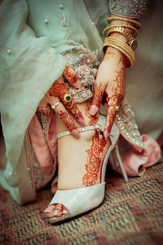 a woman with henna on her hands and feet