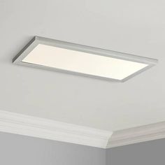 a bathroom ceiling light that is on top of a white wall and has a dim light above it