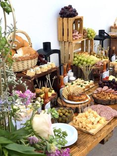 a table filled with lots of different types of food on plates and trays next to each other