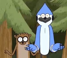 a blue bird standing next to a brown monkey in the middle of a wooded area