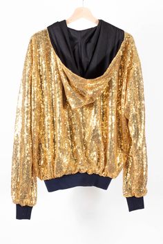 Gorgeous Gold Rush Bomber Jacket. Handmade in limited quantity, this jacket is beautifully made, with the shiniest of gold sequin material, hooded, with quality cuffs and lining. A firm favourite, and perfect for the festive season! Available in S 8-10-12 UK Size, L 14-16-18 Gold Sequined Outerwear For Winter, Winter Tops With Contrast Sequin, Winter Contrast Sequin Tops, Long Sleeve Outerwear For Party And Festival, Trendy Hooded Outerwear For Party, Long Sleeve Sequined Outerwear For Festivals, Winter Glitter Long Sleeve Outerwear, Hooded Fall Party Outerwear, Gold Sequin Jacket