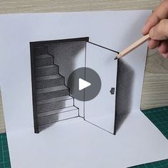 someone is drawing stairs on paper with a pencil