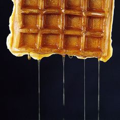 two waffles with syrup dripping from them