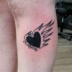 a couple of tattoos on the legs of someone's legs, one with a heart and wings