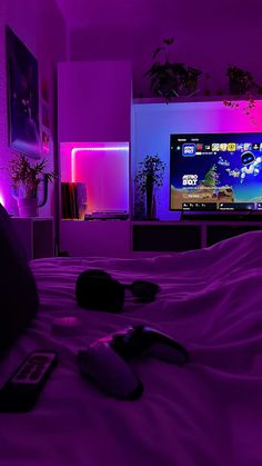 a bedroom with purple lighting and a flat screen tv