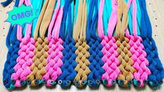 there are many different colored braids on the table with one pink and one blue