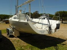 a white sailboat is parked on the grass