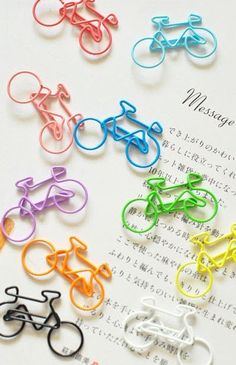 several different colored bicycle clips sitting on top of a piece of paper