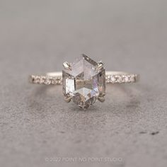 an engagement ring with a large diamond in the center and small diamonds on the side