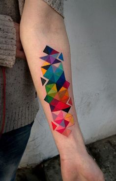 a colorful geometric tattoo on the arm