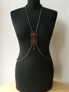 summer, bodychain, handmade bodychain, custom necklace, bodynecklace, body jewellery, crystal necklace,silver bodychain, handmade necklace, It is handmade, and its design is inspired by mandalas. The chain is bronze, and at the center on the chest it has two figures of filigree adorned with a red brilliant crystal in the center. Take a look at our different models of mandala bodychains, they are comfortable, and lightweight. You can use them every day to brighten any outfit and give it a special Handmade Body Chain For Festivals, Bohemian Metal Body Chain With Adjustable Chain, Handmade Bohemian Body Jewelry For Beach, Bohemian Metal Body Chain For Festivals, Bohemian Handmade Body Jewelry For Beach, Bohemian Adjustable Body Chain, Adjustable Metal Bohemian Body Chain, Bohemian Adjustable Metal Body Chain, Adjustable Bohemian Metal Body Chain