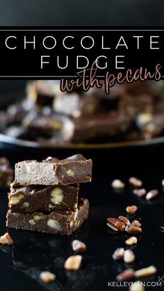 chocolate fudge with pecans stacked on top of each other in front of a plate