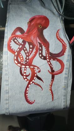 an octopus painted on a denim jacket