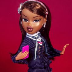 the doll is wearing a blue suit and pink purse