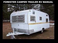 an old camper trailer is parked in the dirt