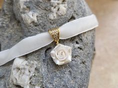 "White Velvet ribbon choker with sculpted pearl rose. Material of rose is polymer clay. Each petal of flower made by hand Dia flower about 13-15 mm/0.45- 0.55 \" Length of necklace is adjustable:  10-12 inches/ 25,4 - 30,5 cm 11-13 inches/ 28-33 cm 12-14 inches/ 30.5- 35.5 cm 13-15 inches/ 33-38 cm 14-16 inches/ 35.5 cm-40.5 cm 15-17 inches/ 38,1 cm- 43,2 cm 16-18 inches/ 40.6 cm- 45.7 cm 17-19 inches/ 43 cm - 48 cm 18-20 inches/ 45,5- 50.8 cm      Τhe length you choose considered to be with lobster clasp and one connecting ring +2 inches extending chain. Width of ribbon 10 mm / 0.4 inch If you need other length of necklace let me know and I will make it for you. Polymer clay isn't afraid of water, strong and non-toxic. Gorgeous gift for women and girls as handmade item ALL CHOKERS - https Elegant Polymer Clay Jewelry With Flower Charm, White Pendant Choker As Gift, Elegant Polymer Clay Necklaces For Gifts, Elegant Rose Design Jewelry Choker, Elegant Polymer Clay Necklace For Gifts, Elegant Rose Design Choker Jewelry, Elegant Rose Design Choker, Elegant Flower Choker As A Gift, Elegant Flower Choker Necklace Gift