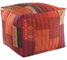 an orange and red patchwork square pillow