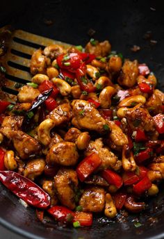 chicken and peppers are being cooked in a skillet