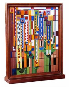 an art piece is displayed in a wooden frame