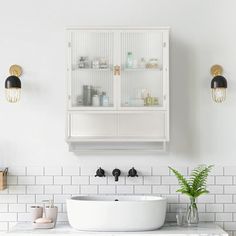 a white sink sitting under a bathroom mirror next to a cabinet with shelves above it