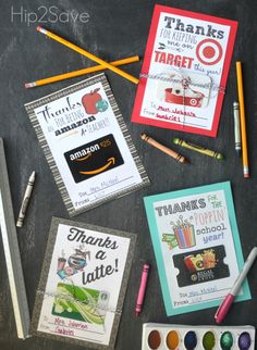 some school supplies are laid out on a blackboard with colored pencils and markers