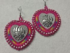 Hand-made beaded earrings: Colors: Pink w/florescent rainbow middle: Bearclaw  Closure: Hook size: 2 inches Rainbow Beaded Round Earrings As Gift, Adjustable Multicolor Earrings With Silver Beads, Multicolor Earrings With Silver Beads For Gift, Multicolor Silver Beaded Earrings For Gifts, Nickel Free Rainbow Beaded Earrings For Gifts, Multicolor Heart Beads Earrings For Gift, Handmade Multicolor Heart-shaped Beaded Earrings, Multicolor Beaded Earrings With Silver Beads For Gift, Handmade Multicolor Heart Beaded Earrings