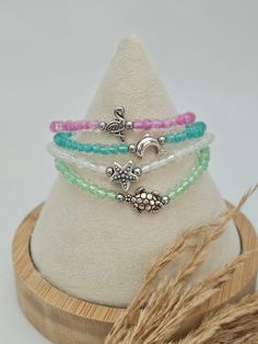 Embrace the beauty of the ocean with our coastal stretchy bracelet sets. Handcrafted with love, this bracelet features glass beads in seashore hues, accented with either a sea turtle, dolphin, starfish or flamingo charm. It's a perfect accessory for those who love the ocean and its captivating marine life. Stack them up OR wear them separately  Features: Glass Beads: Each bead is carefully selected in calming shades of the seashore Stretchy Design: The elastic cord ensures a comfortable snug fit in multiple wrist sizes, making it easy to slip on and off. Alloy Charm: Mix & Match ! Pick out your favorites. Choices for you to choose from are Dolphin, Starfish, Flamingo and Sea Turtle Charm Bracelet. The adorable charm bracelets serve as a symbol of protection, longevity, and a deep connectio Adjustable Faceted Beads Bracelet For Beach, Adjustable Faceted Beaded Bracelets For Beach, Bohemian Beach Stretch Bracelet With Faceted Beads, Bohemian Stretch Bracelet With Faceted Beads For Beach, Adjustable Stretch Bracelet With Spacer Beads For Beach, Casual Beaded Crystal Bracelet For Beach, Bohemian Green Crystal Bracelet For Beach, Czech Glass Round Bead Bracelets For The Beach, Czech Glass Beaded Bracelets For Beach