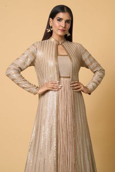 Beige longline jacket with golden, silver and tonal sequin embroidery in striped pattern. Comes with sequined bodice anarkali in crinkled textured base and a solid skirt with an attached cancan. - Aza Fashions Long Sleeve Nehru Jacket With Cutdana For Party, Gold Long Sleeve Anarkali Set For Formal Occasions, Elegant Gold Nehru Jacket With Cutdana, Formal Gold Long Sleeve Anarkali Set, Elegant Long Sleeve Jacket Dress For Festive Occasions, Elegant Long Sleeve Festive Jacket Dress, Fitted Gold Outerwear With Zari Work, Gold Long Sleeve Anarkali Set With Cutdana, Elegant Gold Outerwear With Zari Work