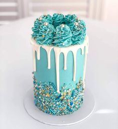 a blue and white cake with flowers on top