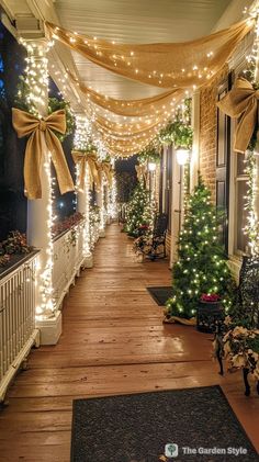 the front porch is decorated with christmas lights and garlands