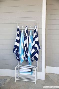 three blue and white towels hanging on a rack