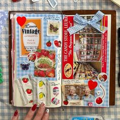 an open book with pictures and magnets on the pages, next to other items