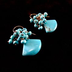 "These Arizona turquoise earrings have a pretty robin's egg blue. They are polished to a high shine and so gorgeous! I have topped them with faceted Sleeping Beauty rondelles. The turquoise are smooth and measure 17x14mm. The rondelles measure 3.5mm. I have wrapped them simply withhold filled wire and hung the gemstone clusters from gold filled French style ear wires. The earrings measure 1 1/4\" from the top of the ear wires." Turquoise Teardrop Faceted Earrings, Turquoise Faceted Teardrop Earrings, Faceted Turquoise Teardrop Earrings, Elegant Faceted Turquoise Earrings, Elegant Turquoise Faceted Earrings, Handmade Turquoise Briolette Earrings, Black Freshwater Pearls, Peacock Pearl, Robin's Egg Blue