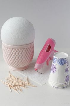 there are some crafting supplies on the table next to each other, including an egg and cotton swabs