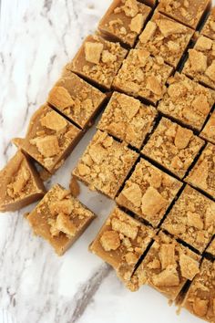 several squares of peanut butter fudge on a marble surface