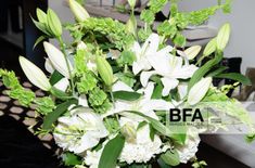 a vase filled with white flowers on top of a table