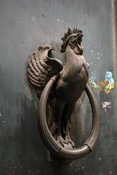 a metal door knockle with a rooster on it