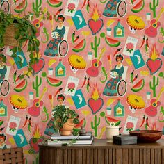 a colorful wallpaper with cactus, flowers and other items on top of a dresser