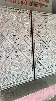 two white decorative tiles sitting next to each other