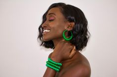 The Miriam Hoops are traditional earrings hand made by artisans in Gambia using traditional techniques exclusive to the artisans know as the Tegaa. These crafting techniques are only accessed within this artisan group and passed down through generations. The hoops are hand-wrapped in multi-color dyed eco-silk threads with spiral detailing. Pair with the matching stackable Rohey cuff for sustainable resortwear at it's finest! Hand made in Gambia Eco-friendly & sustainable 5% of proceeds donated t Resort Chic, Traditional Earrings, Spiral Pattern, Hand Wrap, Silk Thread, Traditional Techniques, Resort Wear, Pure Silk, Rich Color