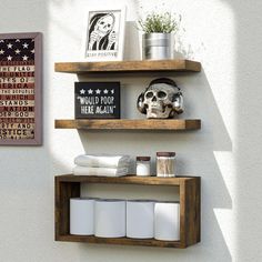 two wooden shelves with various items on them and one has a skull in the middle