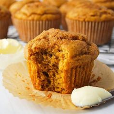 a muffin sitting on top of a plate next to a cupcake and butter