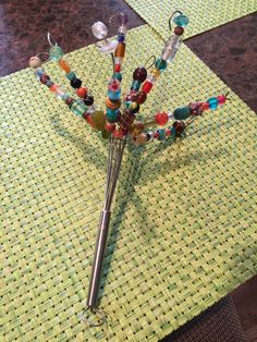 a pair of scissors sitting on top of a table covered in bead and glass beads