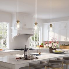 a kitchen filled with lots of counter top space and white counters topped with stools