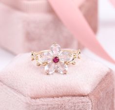 18K Rose Quartz Flower Ring, Pink Crystal Floral Ring, Japan Peach Blossom Ring, Bloom Moissanite Ring, Enchant Daisy Flower, Sunflower Ring ✧･ﾟ: *✧･ﾟ:* Welcome to Charles Davin Jewelry*:･ﾟ･ﾟ✧ Moissanite - a gemstone known to bring in luck in someone's life, the user can give off a look of elegance. You can give your special someone luck whilst showing your love to them. ✶Material: 10K/ 14K/ 18K ✶Main Stone: Rose Quartz 4*5mm (5pcs) ✶Side Stone: Lab Ruby 0.05ct, Moissanite 0.03ct ✶Color: D Color Flower Sunflower, Wedding Rings Photos, Sunflower Ring, Flower Engagement Ring, Peach Blossom, Floral Ring, Fancy Jewelry, Cute Rings, Pink Ring