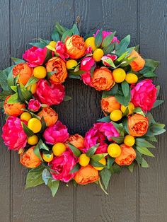 a wreath with orange and pink flowers on it