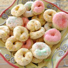 there are many donuts in the bowl on the table and one has sprinkles