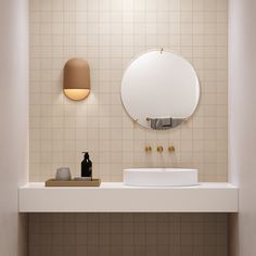 a bathroom with a sink, mirror and soap dispenser on the counter